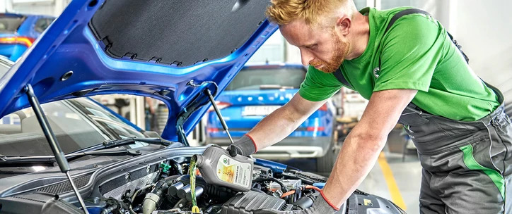 Two Services - Man refilling engine oil